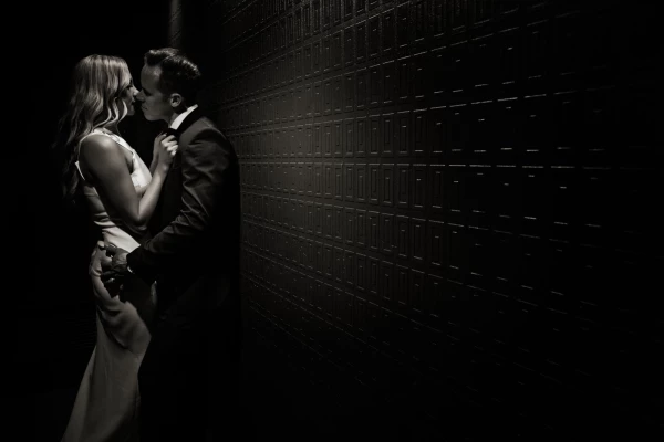 We like to capture what we call a ‘kiss goodnight’ shot of our bride and groom during their reception. It usually serves as a perfect image to end their wedding album.  This shot was in an unusual location. We noticed the hallway into the ladies bathroom at the reception venue had textured wallpaper and dim lighting - we knew it would be perfect for our shot. Although we got a couple of strange looks from some guests, capturing a sexy, intimate moment between our newlyweds outside the toilet, everyone was amazed at the end result. We used a couple of torch lights to give us enough light to create the image and our couple enjoyed their moment alone. We decided to finish this in a sepia tone, it matched perfectly with their classic, elegant outfits. Sometimes the most unusual locations make for amazing images - our couple loved this one, it’s a double page spread in their wedding album.