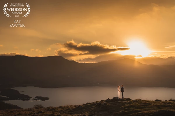 I loved capturing this romantic golden sunset portrait of Amber and Matt in the Lake District. Captured from WallaCrag looking over Derwentwater with the splendor of Catt Bells across the lake. 