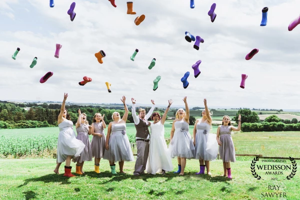 One of my most fun weddings to date, everything was like a festival, sitting on straw, food fans and ice creams, what a wedding. We just did the formal group shot of the girls and thought let's get funky with it, girls dancing throwing the wellies in the air? Of course, they were game.